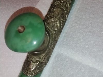 The pipe is constructed from two pieces of apple-green jade, all with a smooth polish. The opaque jade is of a striking apple gr