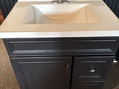 Used vanity, sink, and tap.
