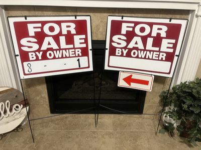 Two for sale by owner signs and stands