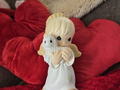 Large- 1999 Precious Moments Universal Statuary angel holding a lamb figurine by Samuel J. Butcher
