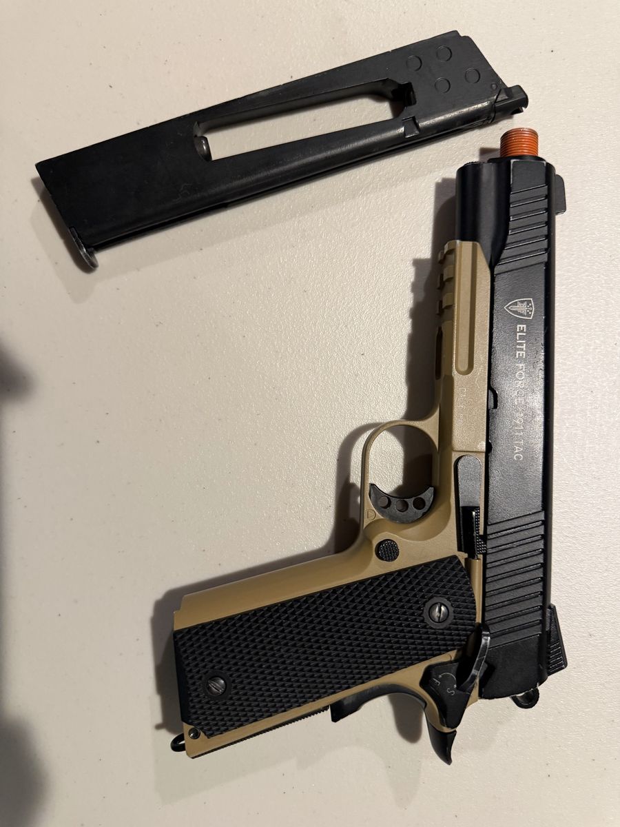 Elite Force 1911 Blowback Airsoft Pistol with an extended mag