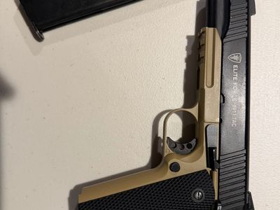 Elite Force 1911 Blowback Airsoft Pistol with an extended mag