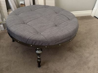 Gray Tufted Round Ottoman with Decorative Nailhead Trim & Turned Legs