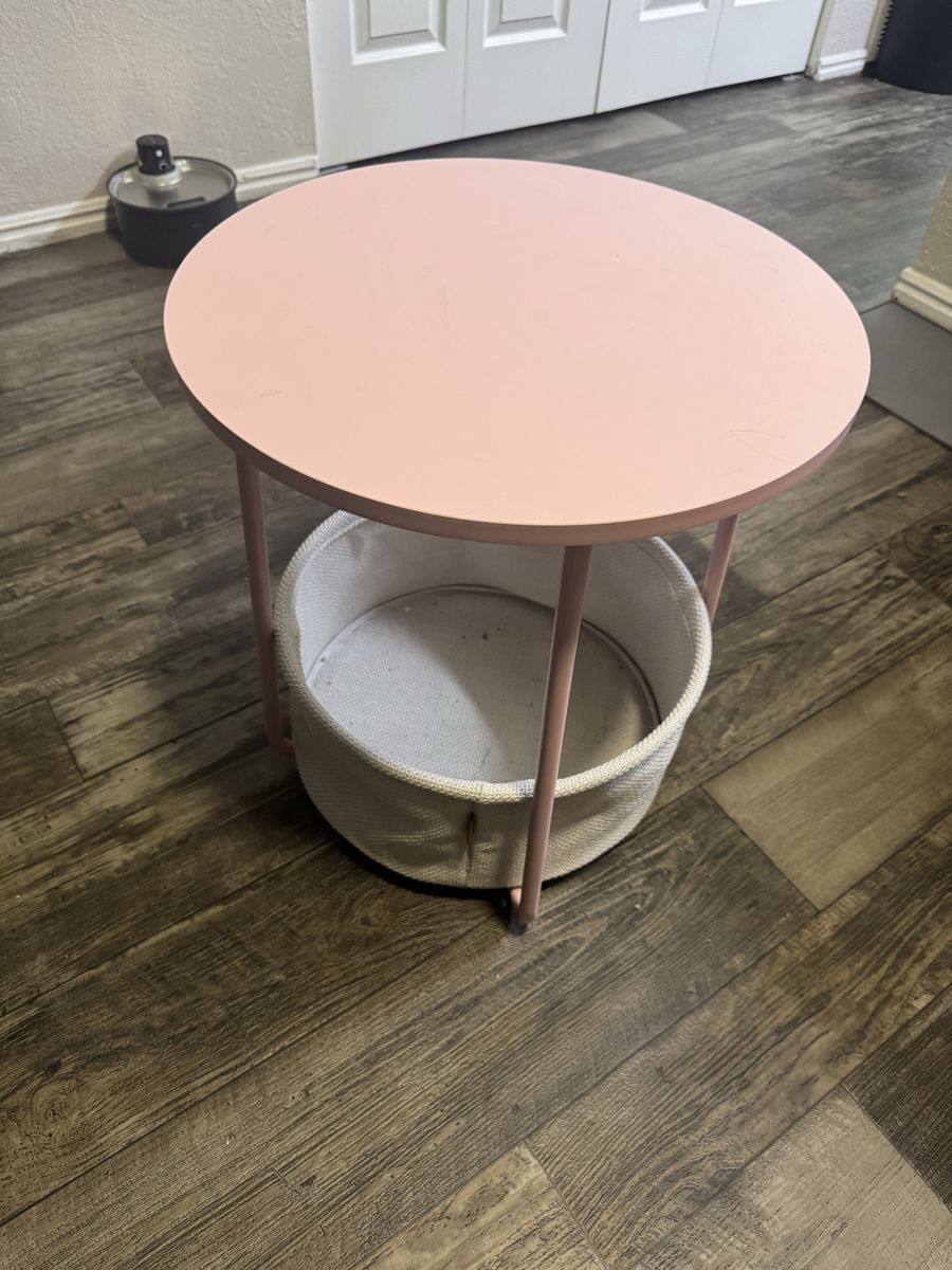 Pink nightstand with basket underneath