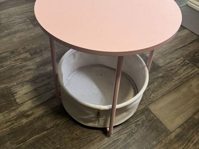 Pink nightstand with basket underneath