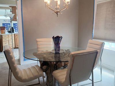 Glass Dining Table with White Leather Chairs