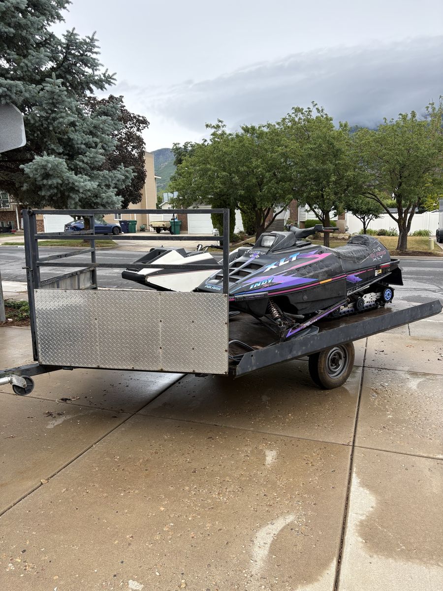 Vintage 1996 Polaris XLT and 1974 Raider snowmobiles with Trailer.