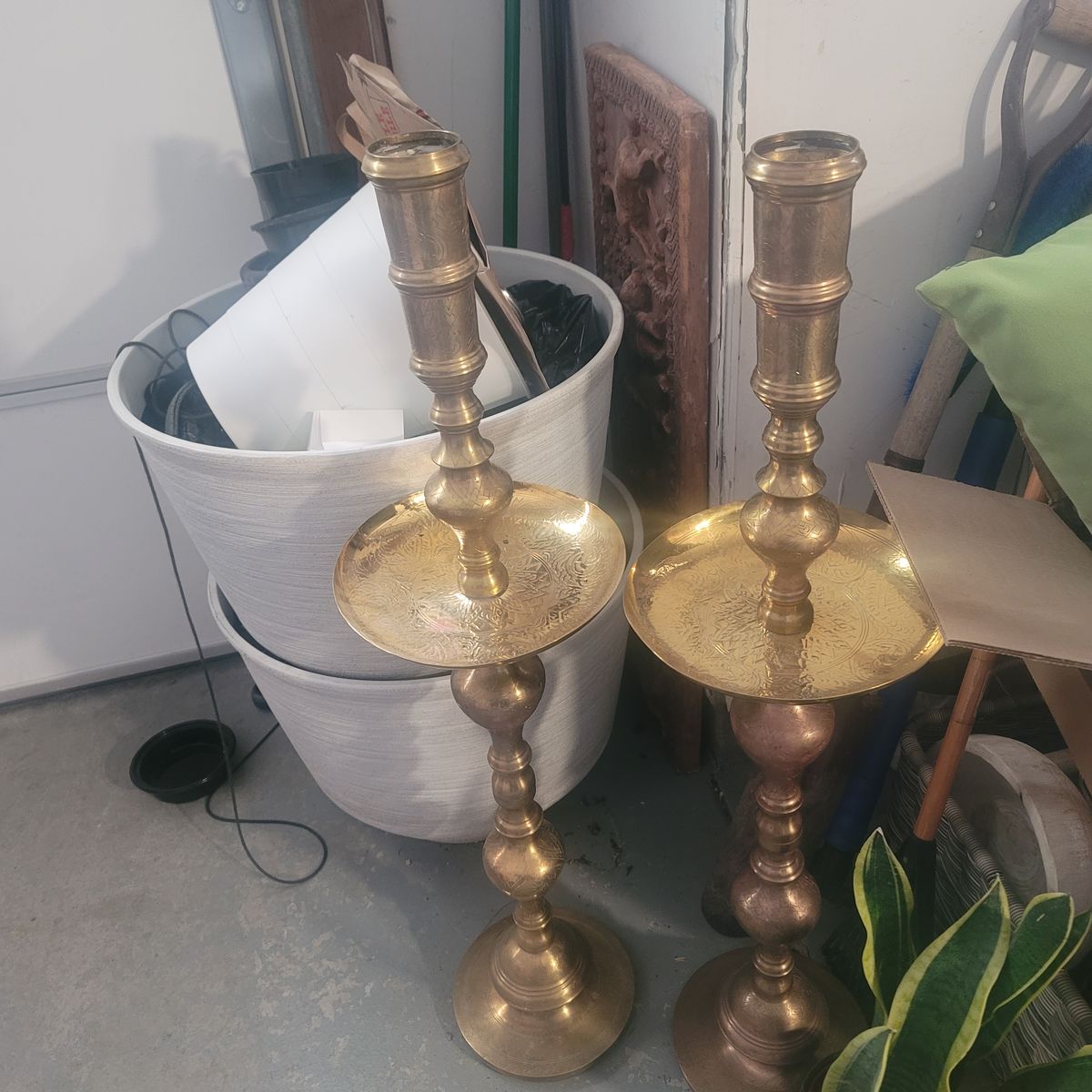 large, ornate items are vintage Moroccan-style brass altar candlesticks, dating from the mid-20th century.