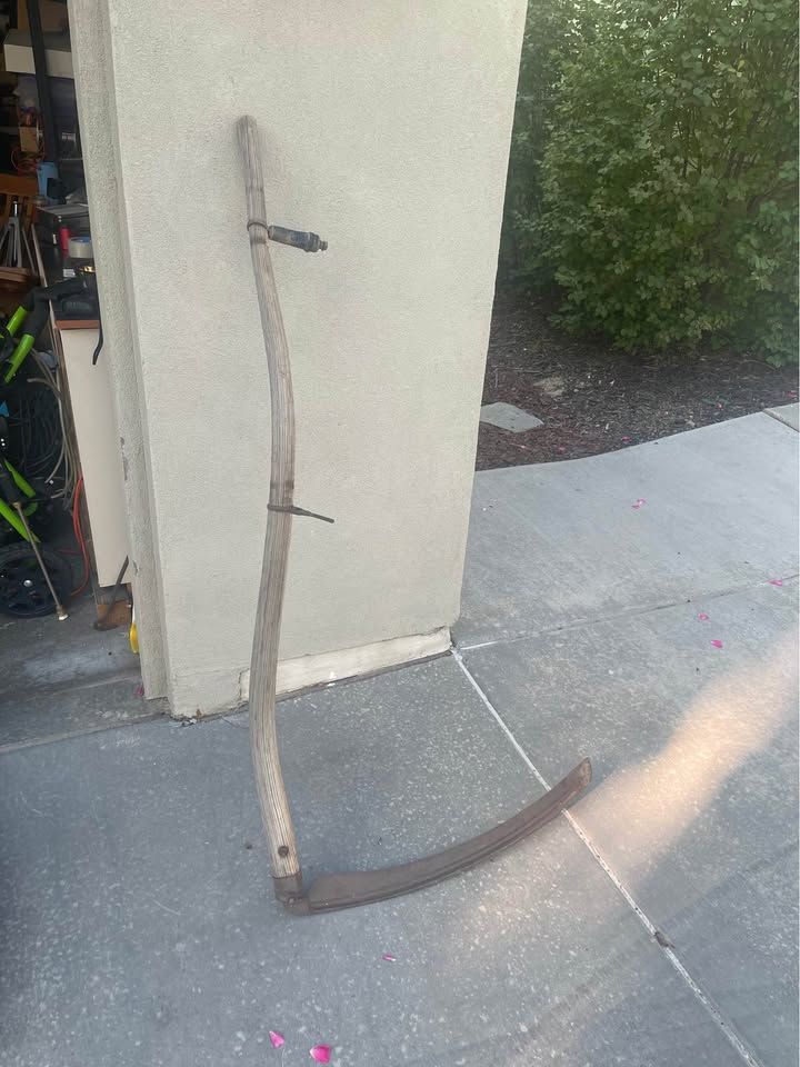 vintage antique scythe, often referred to as a "Grim Reaper" farming tool