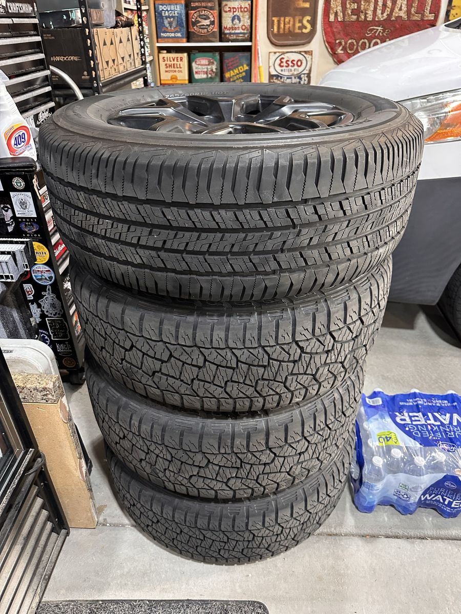 2022 Ford Ranger 265/60 r18 tires and black stock wheels.