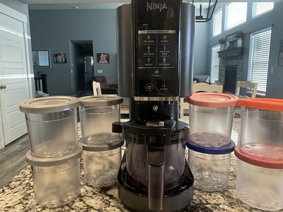 Ninja CREAMi Ice Cream Maker Machine with 9 Containers and Lids.