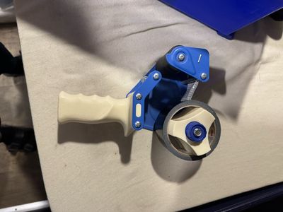 Moving packing tape dispenser