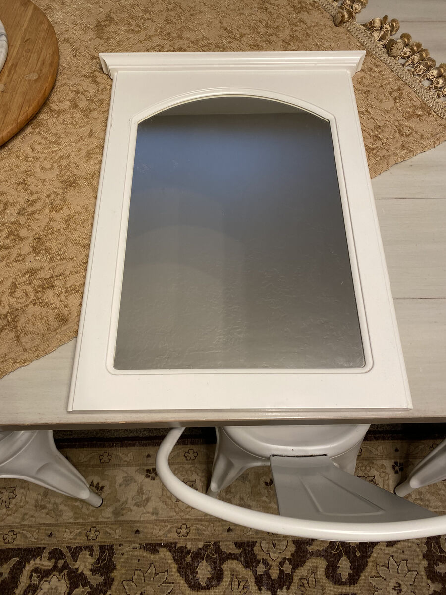 24"×17" white framed mirror