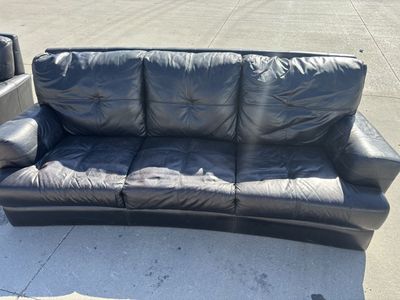 Brown leather couch and loveseat