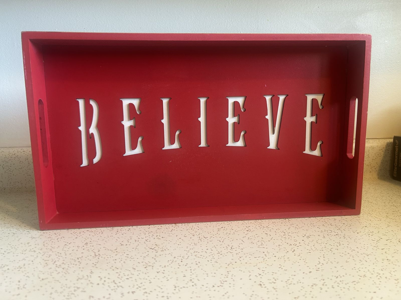 Red Wooden TV Tray Engraved with White Lettering Reading: Believe