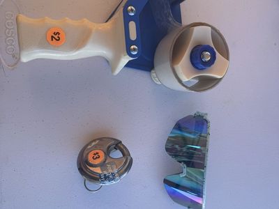 Packing tape, sunglasses, storage unit lock with key
