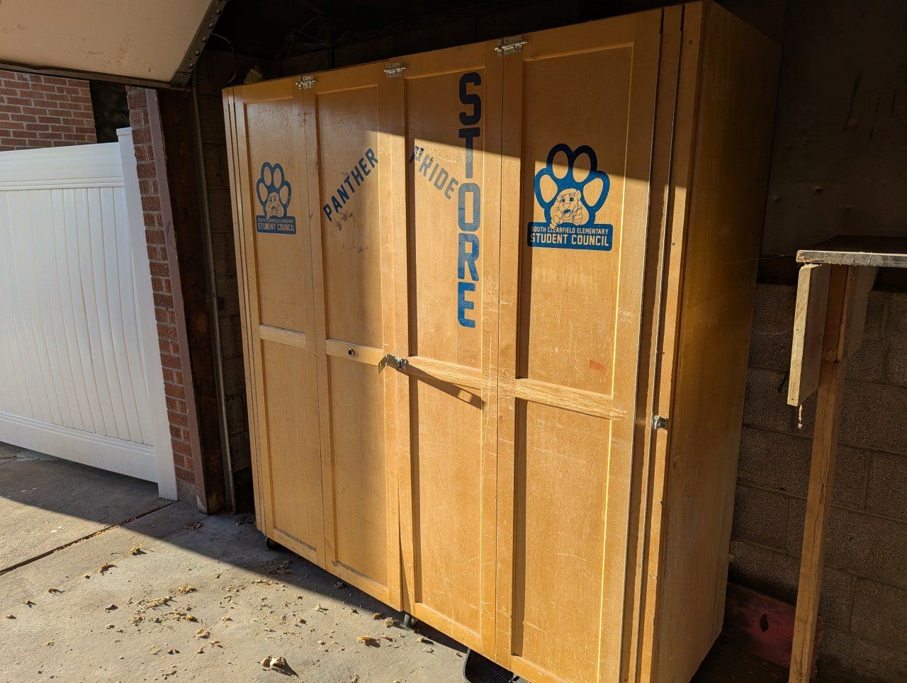 Large Wooden Storage Cabinet on Wheels with Multiple Shelves and Drawers