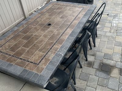 Outdoor Tile Top Patio Dining Table with Matching Black Chairs