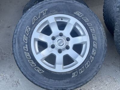 Bridgestone Dueler A/T P285/70R17 Tires & Nissan Titan 17" Wheels - Set of 4