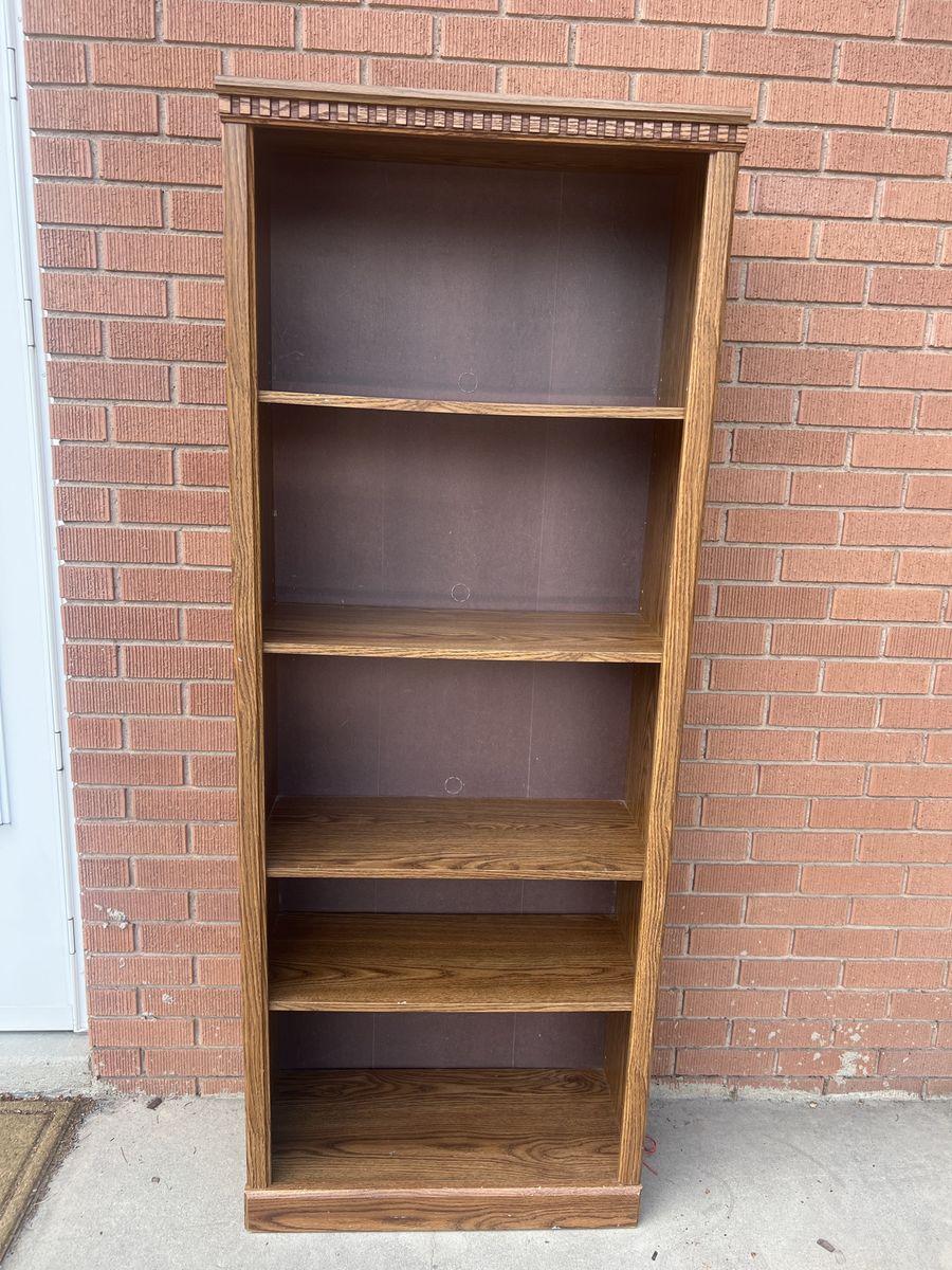 Tall Wooden Bookshelf with Decorative Trim and Multiple Shelves
