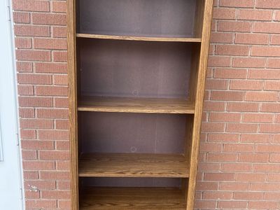Tall Wooden Bookshelf with Decorative Trim and Multiple Shelves