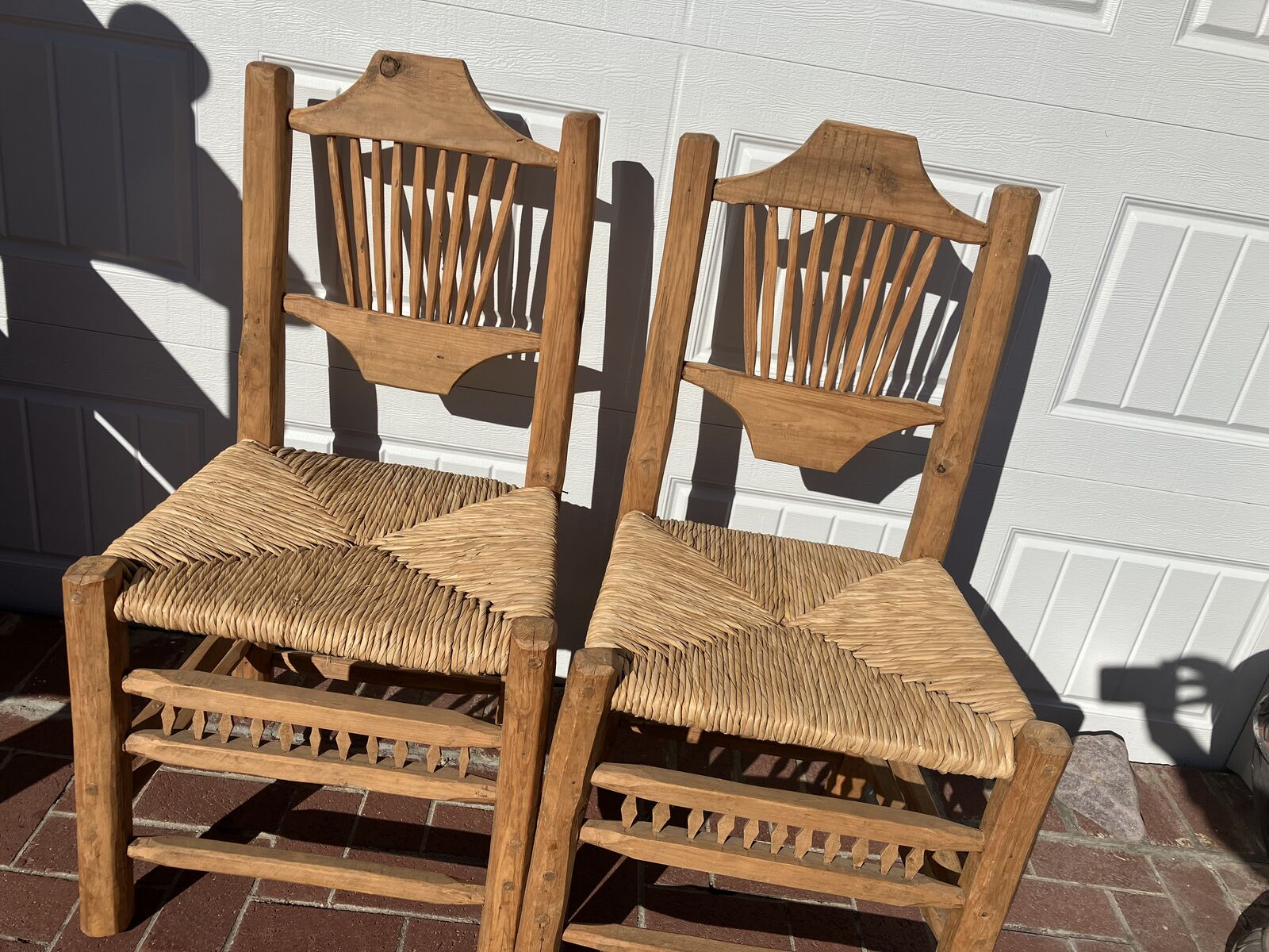 Rustic hand crafted wood chairs with wicker seats