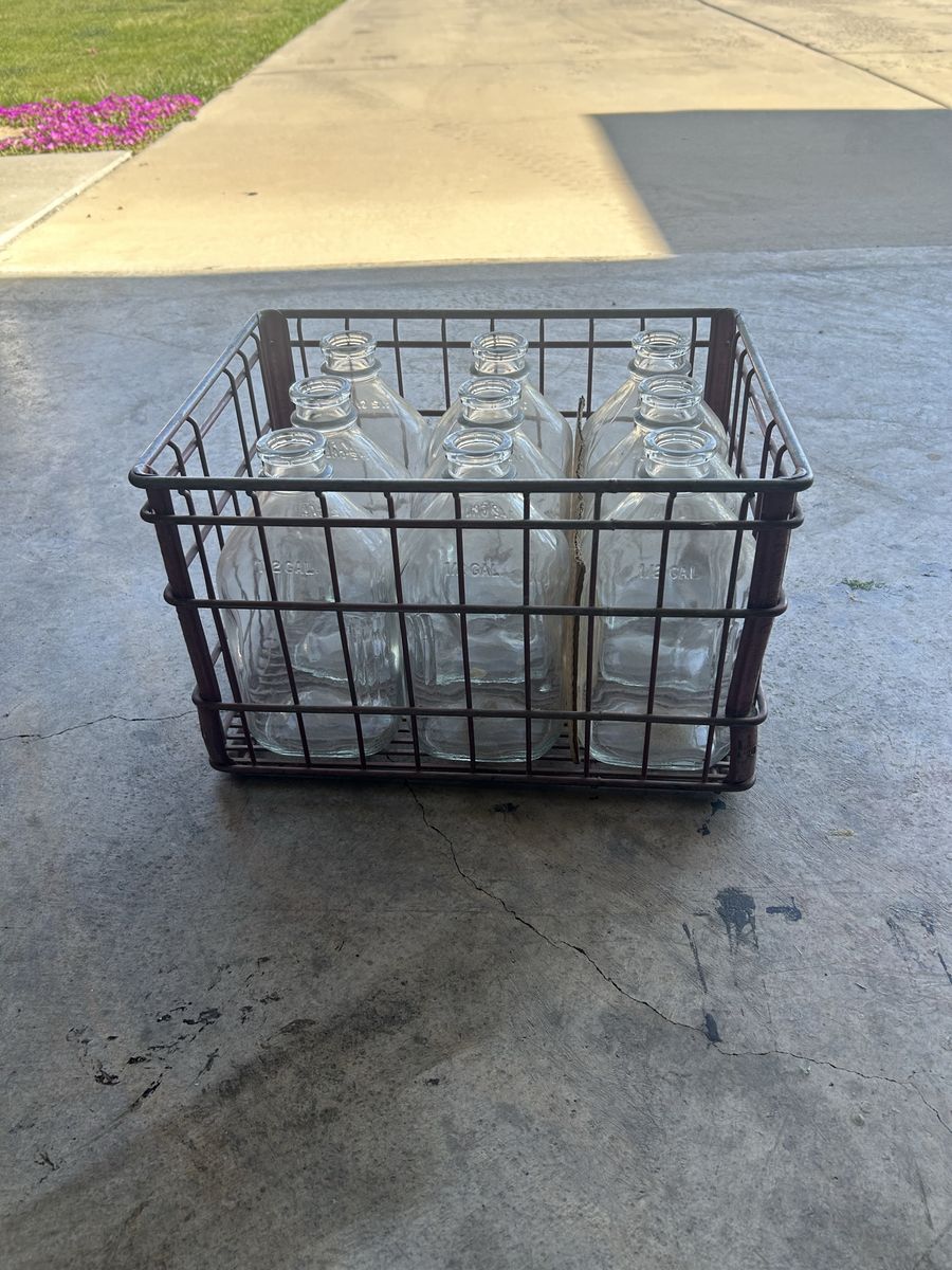 Antique milk crate with 9 jugs