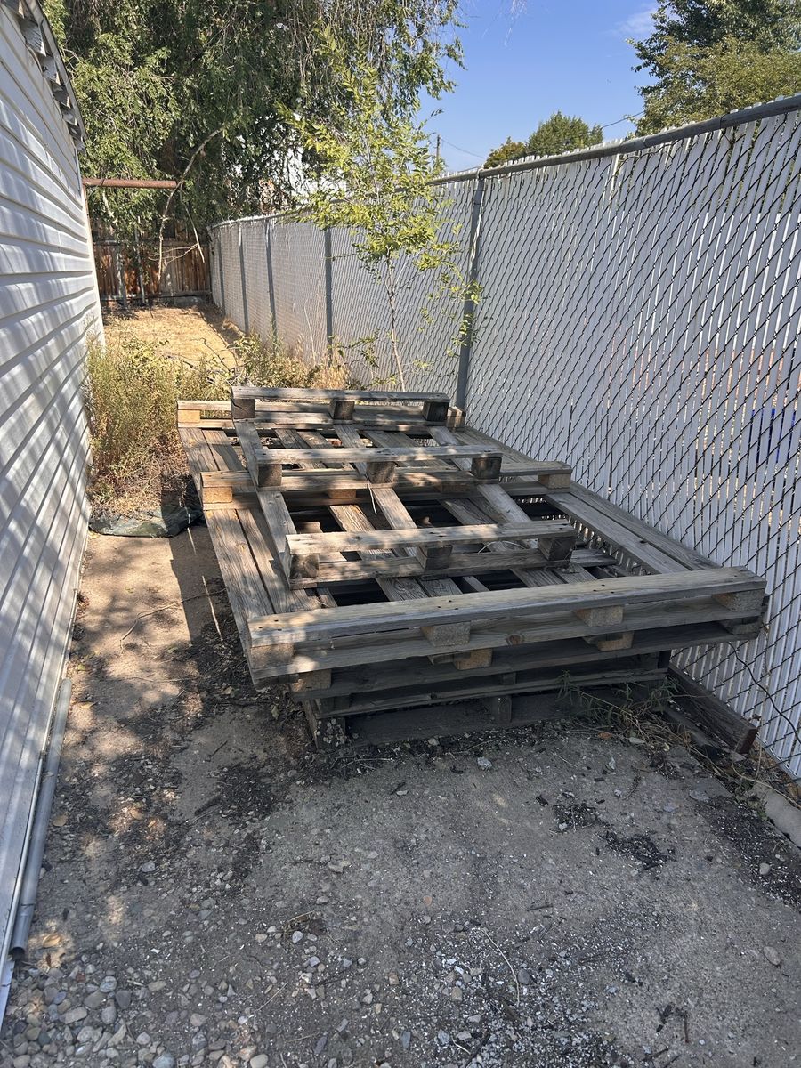 Stack of Old Used Wooden Shipping Pallets