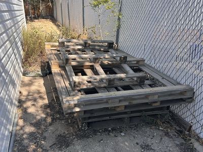 Stack of Old Used Wooden Shipping Pallets