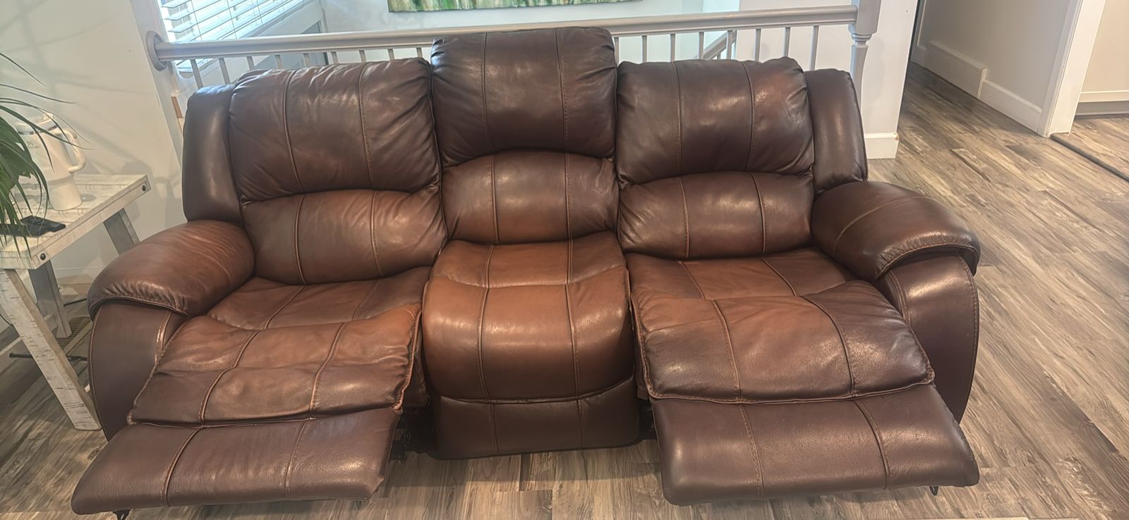 Leather couch with power recliners and headrest on each end