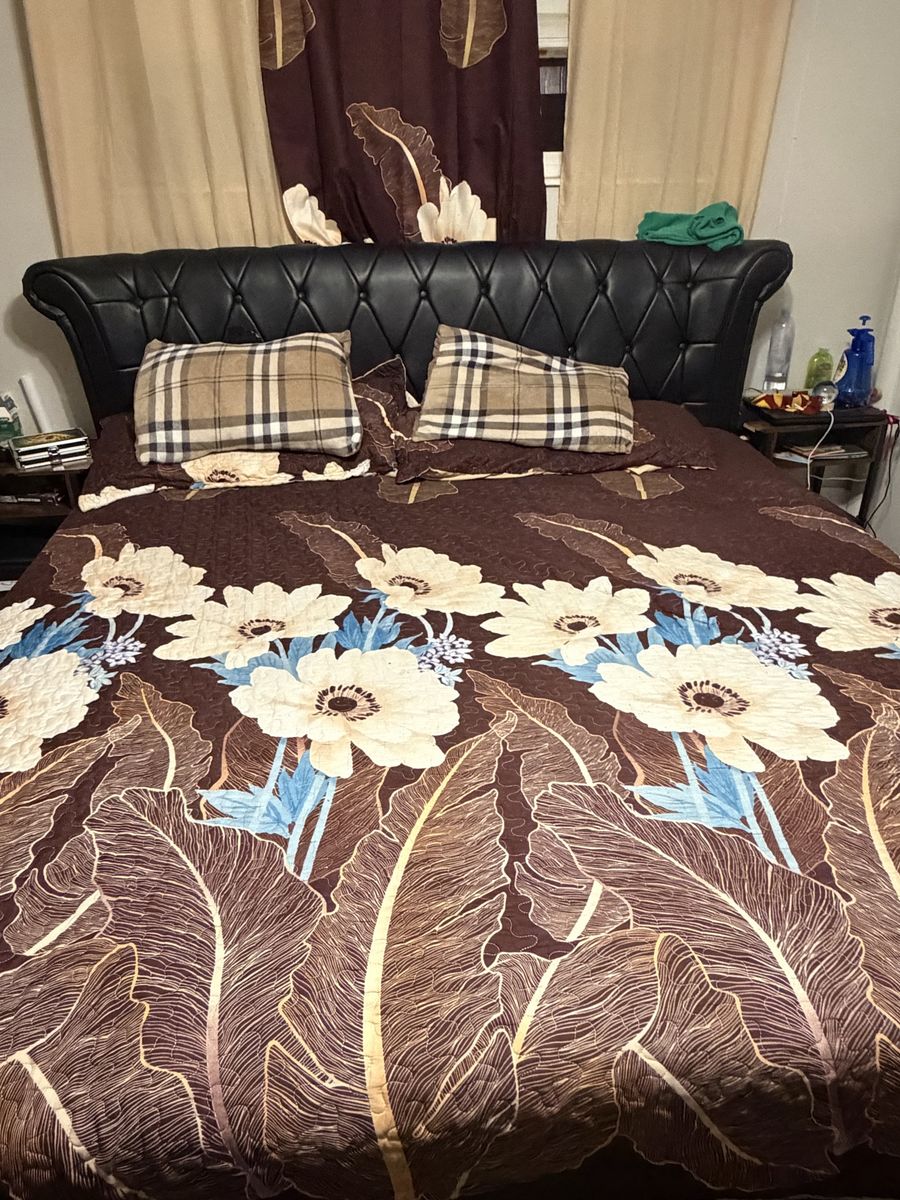 King Size Bed with Tufted Black Leather Headboard and Clean Mattress