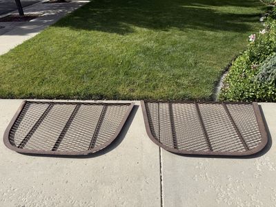Two Brown Window Well Covers
