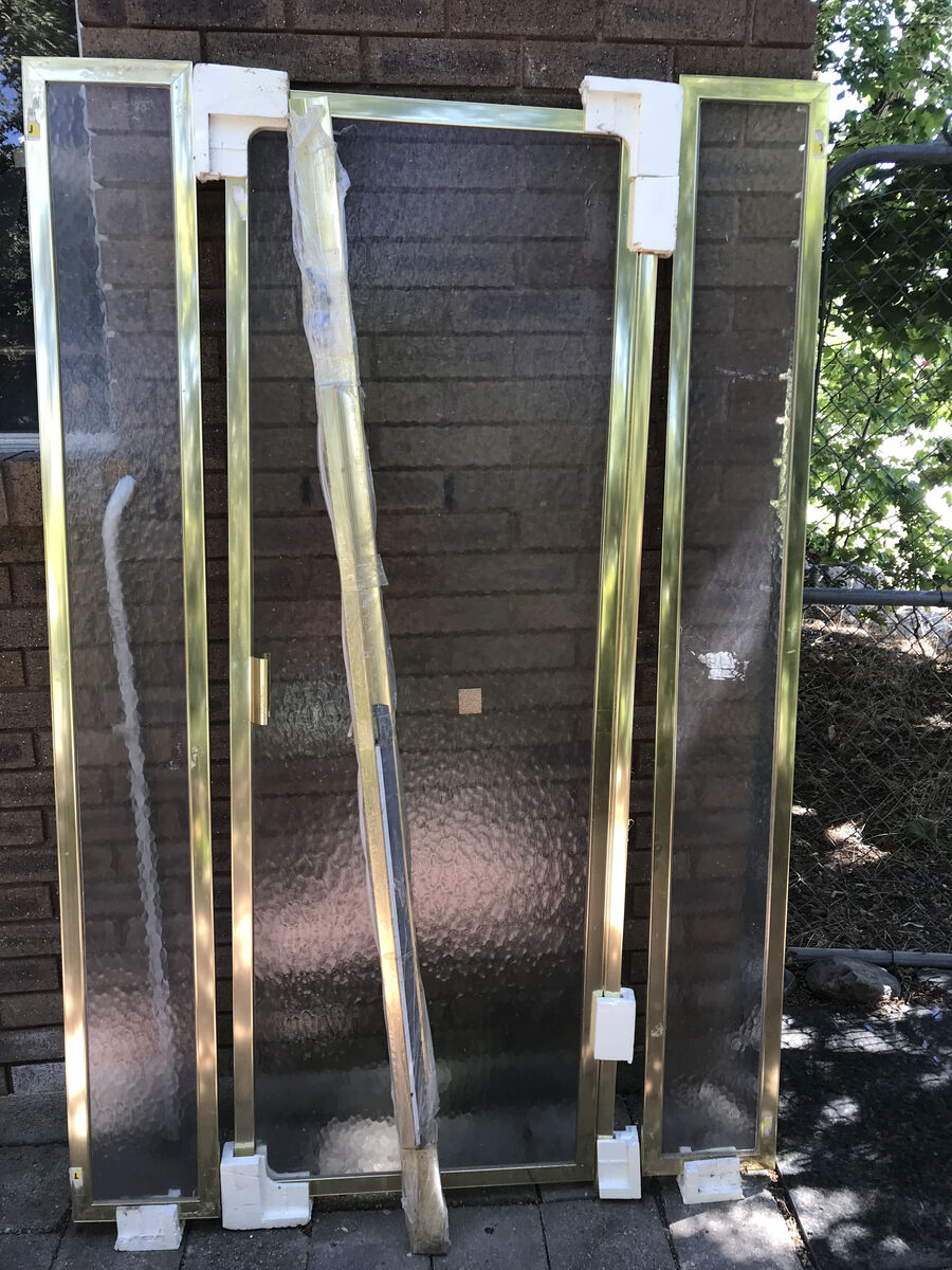 Old style pivot shower door with side panels.