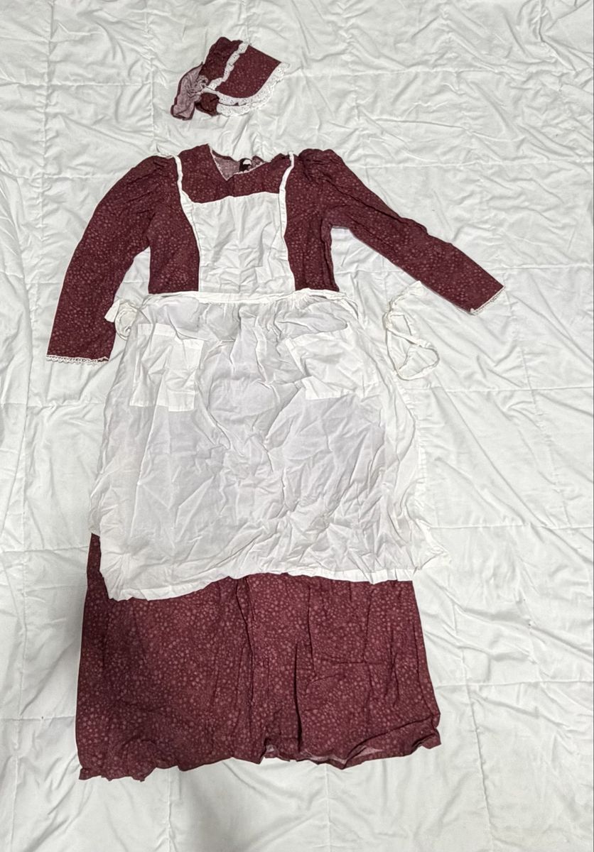 Maroon Pioneer Dress with matching bonnet and white apron.