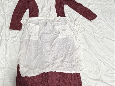 Maroon Pioneer Dress with matching bonnet and white apron.