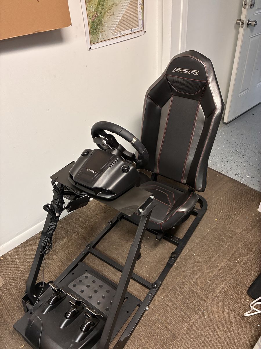 Racing simulator chassis with chair, wheel, shifter, and pedals