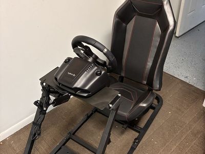 Racing simulator chassis with chair, wheel, shifter, and pedals
