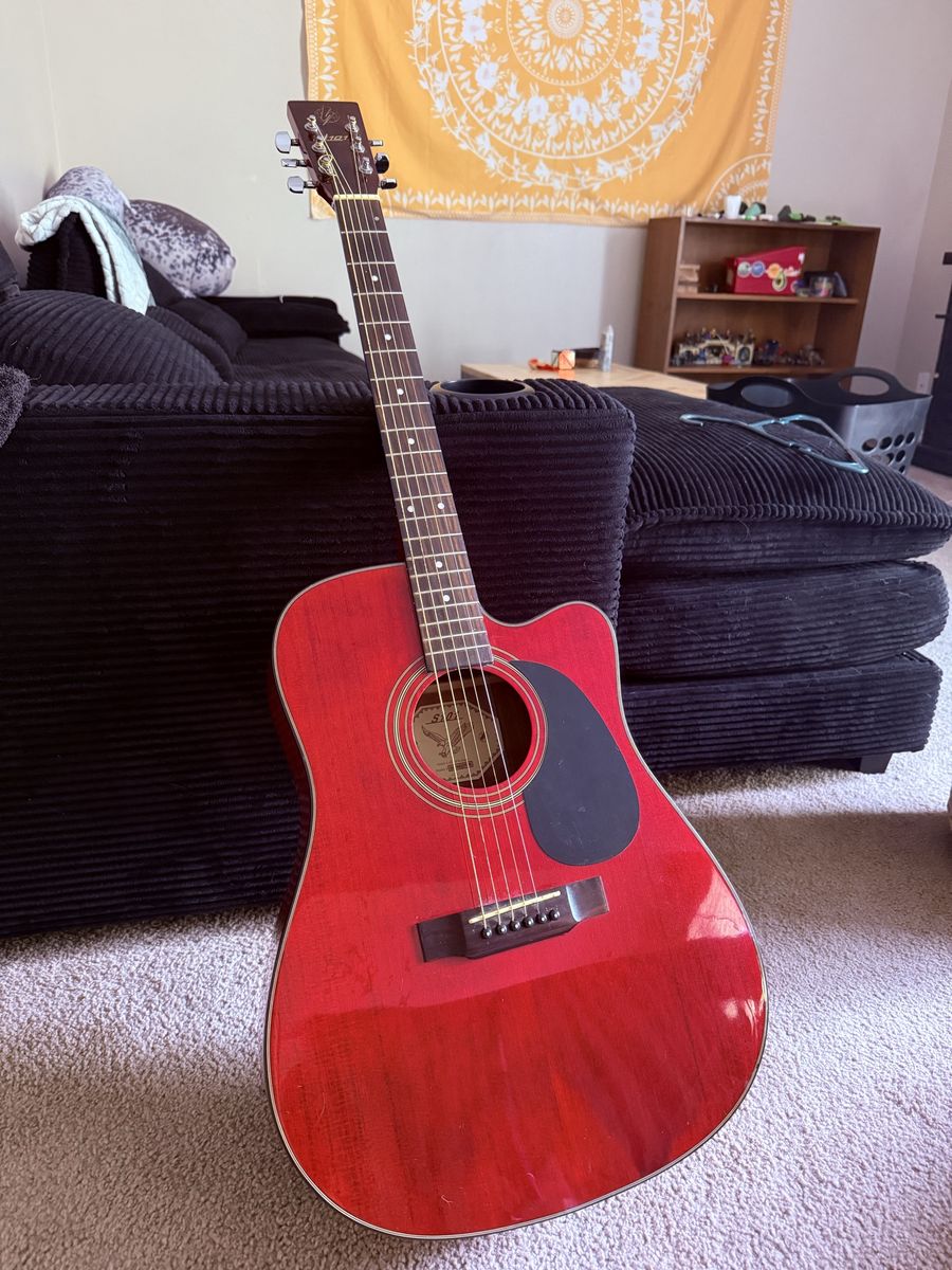 Dark red wooden guitar with bag