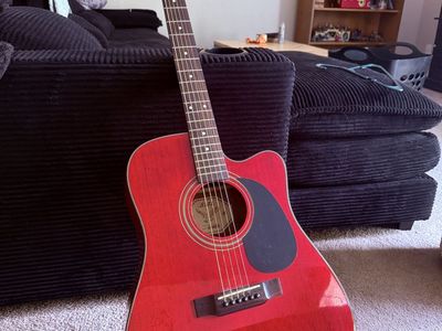 Dark red wooden guitar with bag