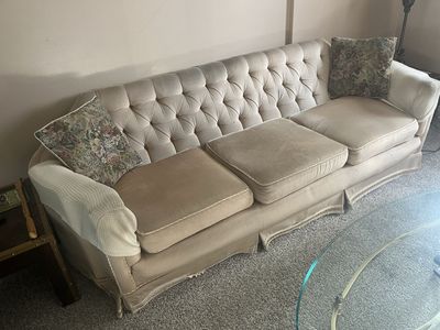 Free. Vintage Tufted Cream Fabric Sofa - 3 Seater with Skirted Base and Floral Accent Pillows