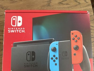 Nintendo Switch Console v2 with Neon Red & Blue Joy-Cons, Dock, Charger, and Super Smash Bros. Ultimate