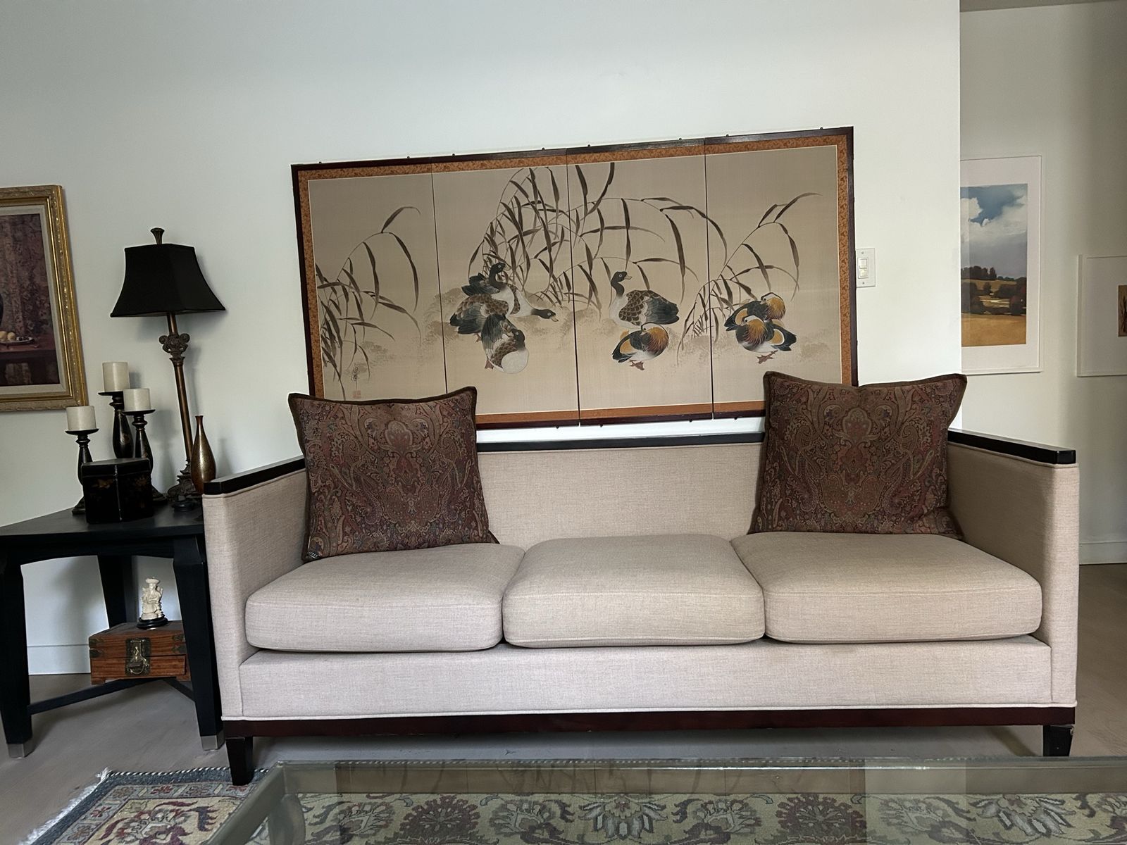 Neutral Fabric Three-Cushion Sofa with Dark Wood Trim and Accent Pillows