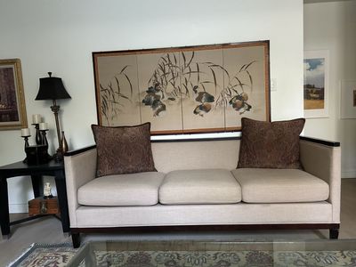 Neutral Fabric Three-Cushion Sofa with Dark Wood Trim and Accent Pillows