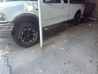 For sale or trade 600$ White Ford F-150 SuperCab Pickup Truck with Camper Shell & Custom Wheels