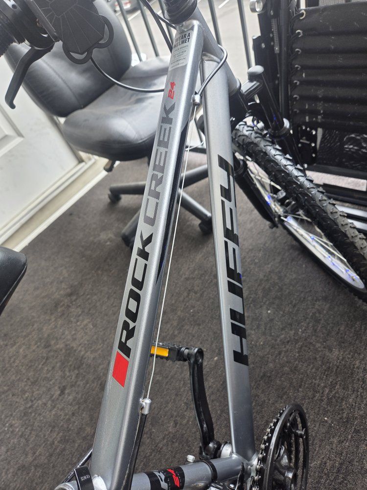 Upgraded Huffy Rock Creek 24" - Near New & Fully Loaded!
​This silver Huffy Rock Creek 24-inch mountain bike is in truly perfect