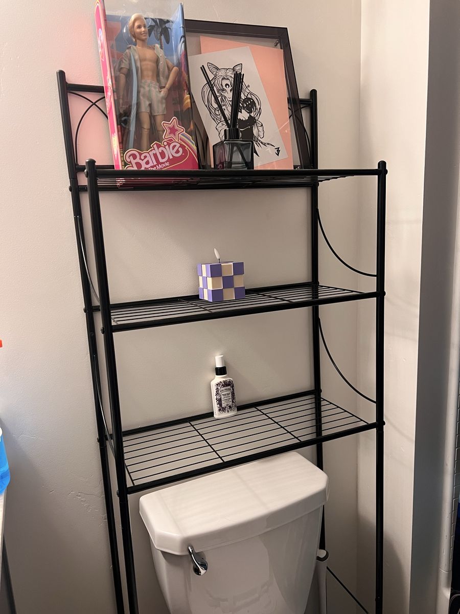 Black metal over the toilet rack