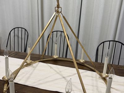 LOVEDIMA 35.4-inch 8-light gold wagon wheel chandelier with an antique brass finish.