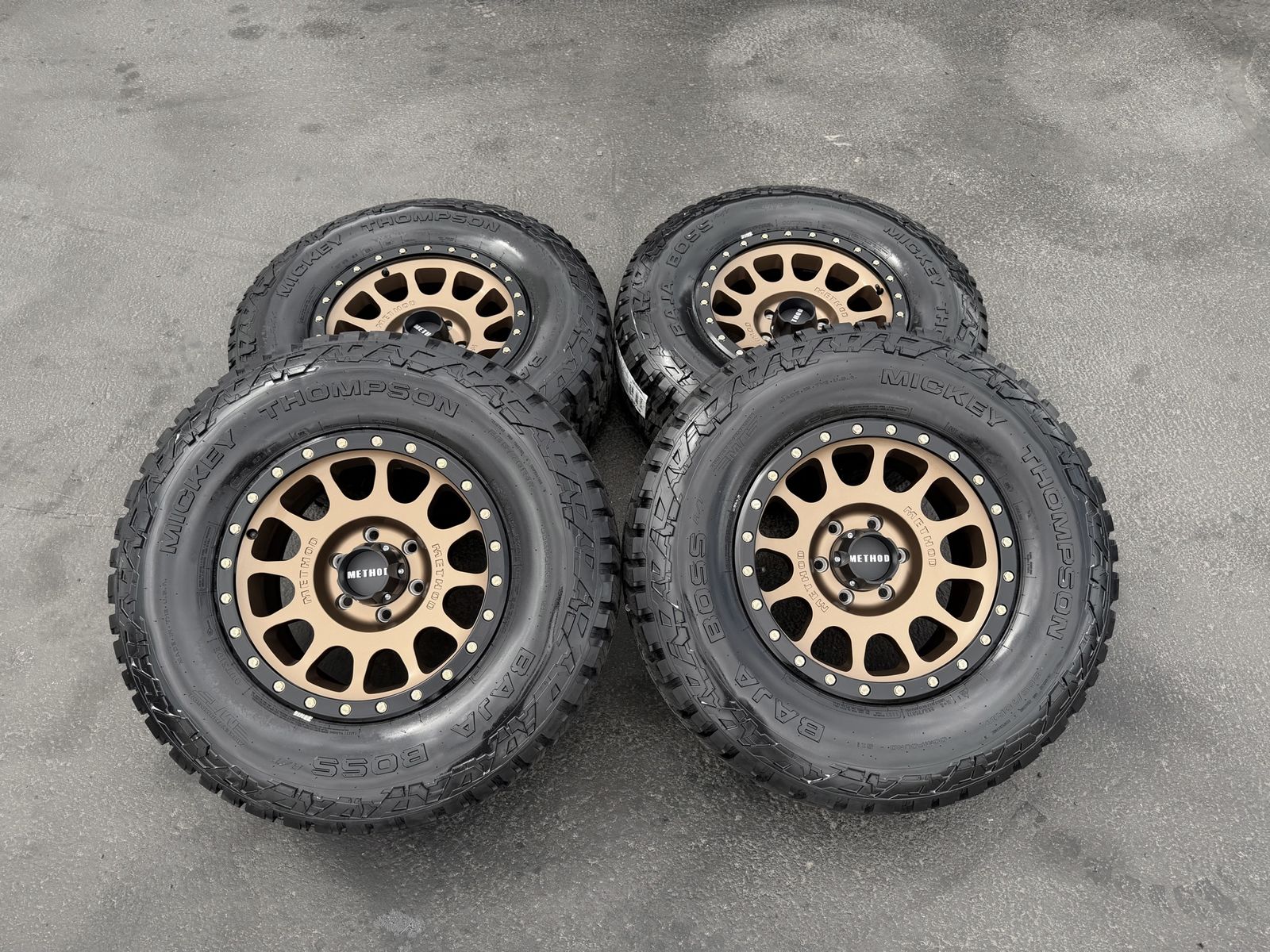 New 285/70r17 Mickey Thompson Baja Boss AT tires Bronze Method MR305 wheels 6x5.5 Toyota Tacoma Chevy Silverado 1500 GMC Sierra