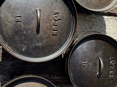 Lodge cast iron Dutch ovens 12" & 14" with bags and lid lifters for sale