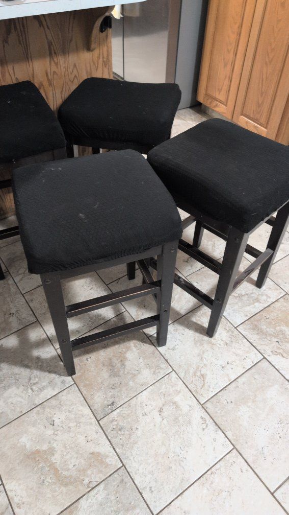 Four Dark Wood Counter Height Bar Stools.